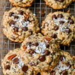Delicious homemade cowboy cookies with oats, chocolate chips, and nuts.