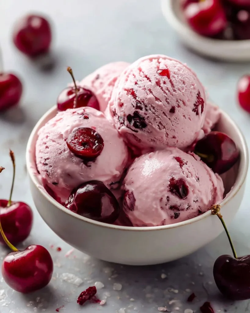 Cherry Greek Yogurt served in a bowl with cherries and mint leaves