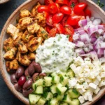 Delicious chicken gyro bowl filled with fresh vegetables and savory chicken served in a bowl.