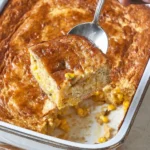 Delicious corn pudding casserole served in a baking dish with garnish