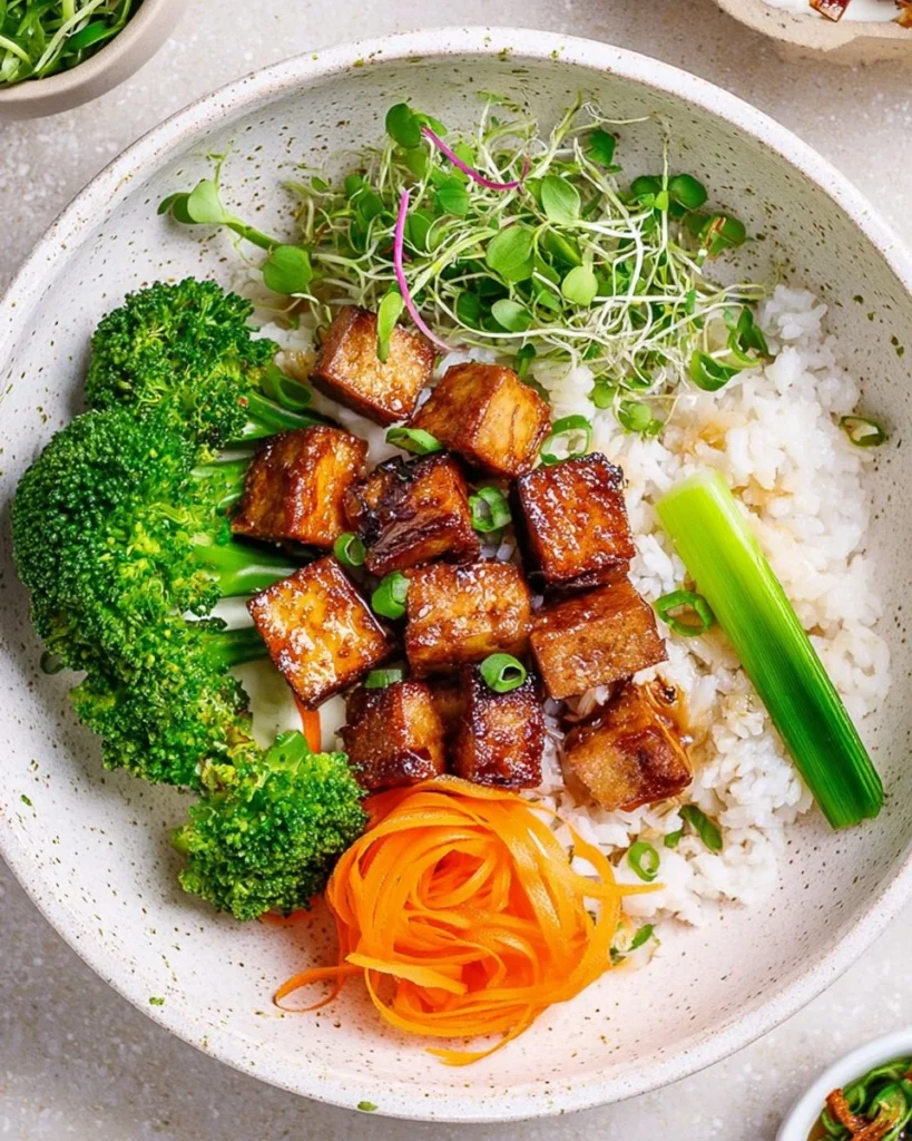 Plate of crispy marinated tofu with fresh garnishes