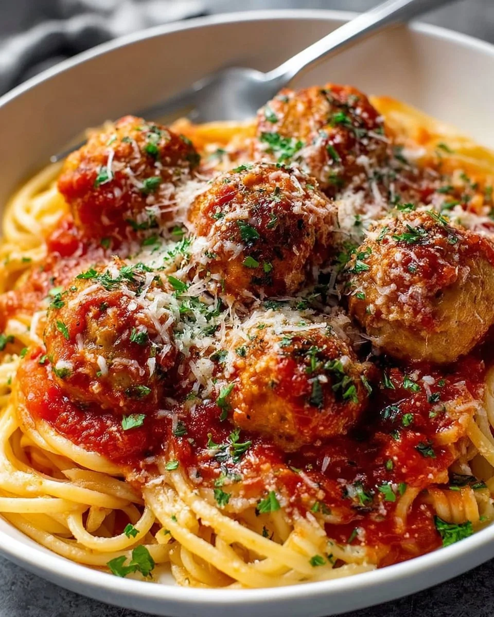 Easy Chicken Parmesan Meatballs served on a plate with marinara sauce and cheese