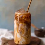 A glass of easy homemade caramel iced coffee with whipped cream and caramel drizzle.