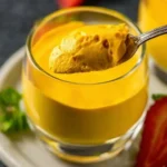A creamy and delicious easy mango mousse topped with fresh mango slices.