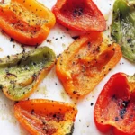 Plate of easy roasted peppers, highlighting their vibrant colors and charred texture.