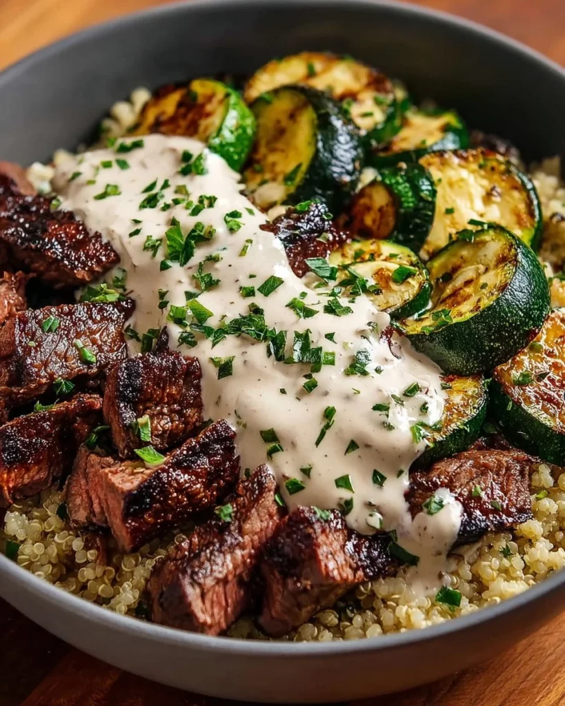 Delicious grilled steak bowl topped with fresh vegetables and sauce