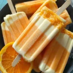 Delicious homemade orange creamsicles on a plate, perfect for summer treats