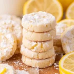 Decorated Lemon Cooler Cookies on a plate with lemon slices