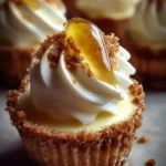 Delicious Lemon Meringue Cheesecakes topped with fluffy meringue and fresh lemon slices.