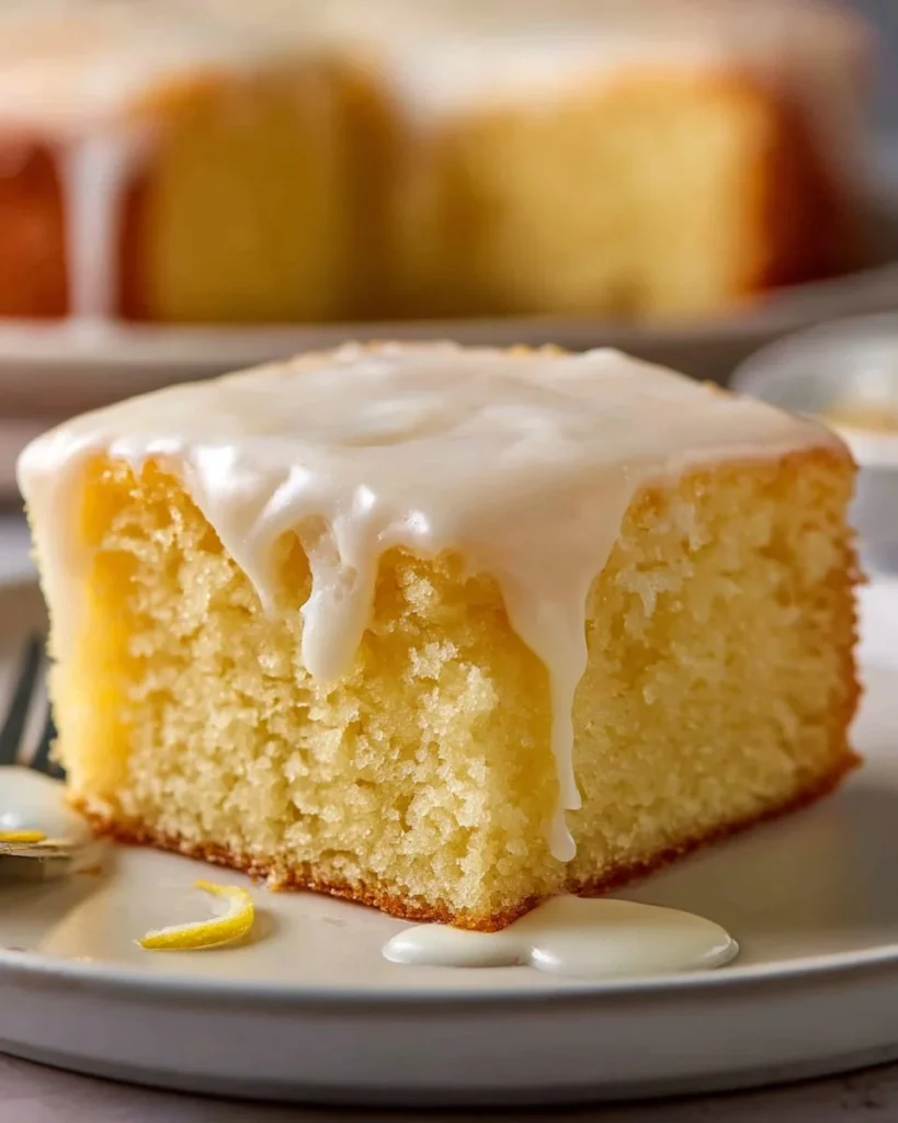 Delicious lemonade poke cake topped with whipped cream and fresh lemon slices