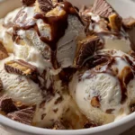 Delicious Moose Tracks Ice Cream served in a bowl with chocolate and peanut butter swirls.