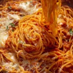 Delicious oven-baked spaghetti served in a dish with cheese and herbs