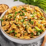 Spicy Thai Pasta Salad with fresh vegetables and zesty dressing served in a bowl.