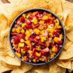 Colorful bowl of Strawberry Mango Salsa with fresh ingredients