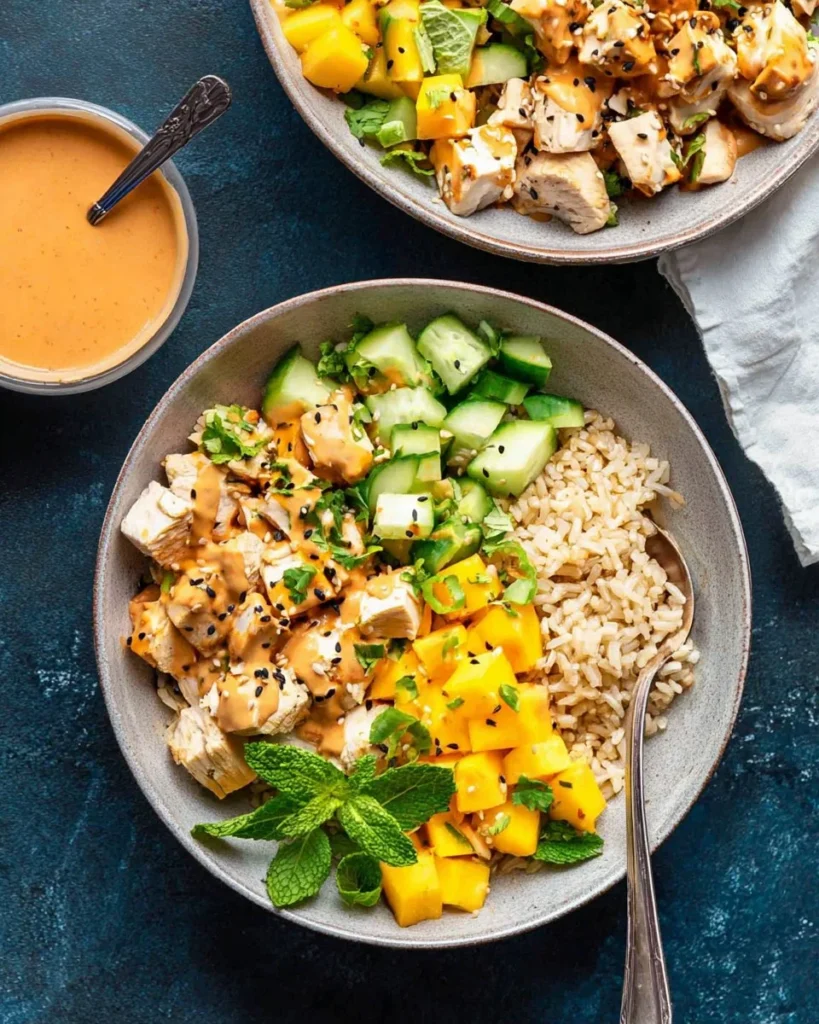 Thai Peanut Chicken Bowls with fresh vegetables and creamy peanut sauce