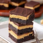 Decadent Buckeye Brownies topped with creamy peanut butter and chocolate glaze.