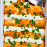Delicious Buffalo Chicken Enchiladas topped with cheese and spicy sauce