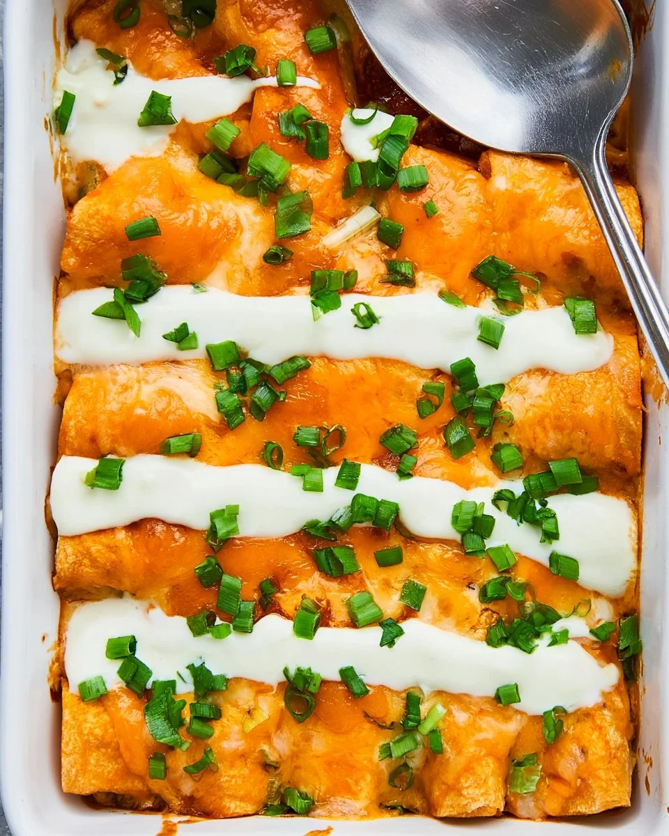 Delicious Buffalo Chicken Enchiladas topped with cheese and spicy sauce