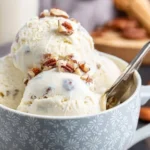 Delicious bowl of butter pecan ice cream topped with nuts