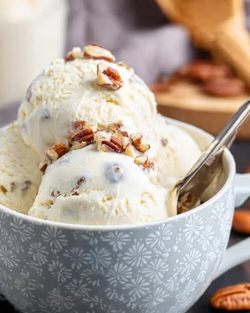 Delicious bowl of butter pecan ice cream topped with nuts