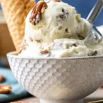 Delicious bowl of butter pecan ice cream topped with crunchy pecans