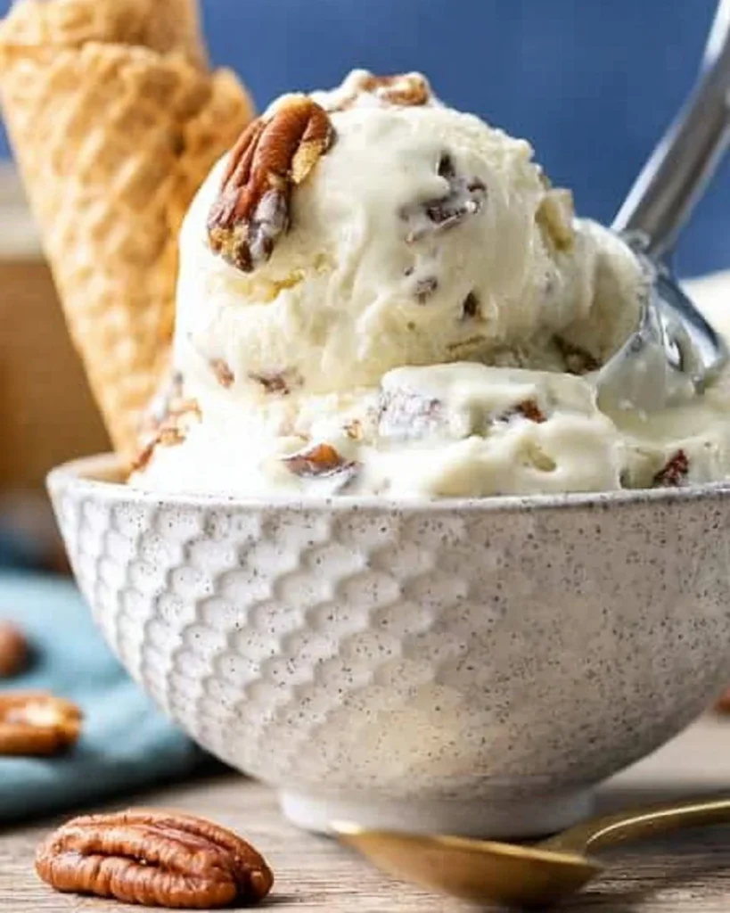 Delicious bowl of butter pecan ice cream topped with crunchy pecans