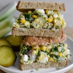 Delicious egg salad with pickles served on a plate.