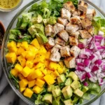 Delicious grilled chicken avocado mango salad with vibrant colors and healthy ingredients