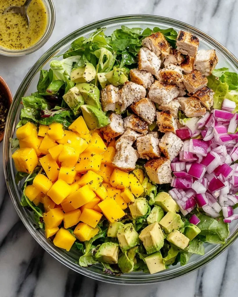 Delicious grilled chicken avocado mango salad with vibrant colors and healthy ingredients