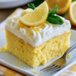 Delicious lemon cake with creamy cream cheese frosting on a decorative plate