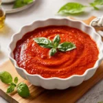 Homemade Pomodoro Sauce in a bowl with fresh ingredients like tomatoes and basil