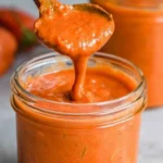 Delicious roasted cherry tomato sauce in a bowl with fresh herbs
