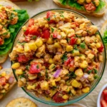Bowl of Southwest smashed chickpea salad with colorful vegetables and spices