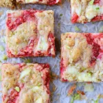 Strawberry and lime white chocolate blondies on a wooden table