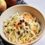 Bowl of fresh Apple Cabbage Slaw with vibrant colors and textures