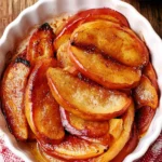 Healthy baked apple slices with no added sugar served on a plate.