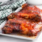 Grilled chicken barbecue served with fresh herbs and sides