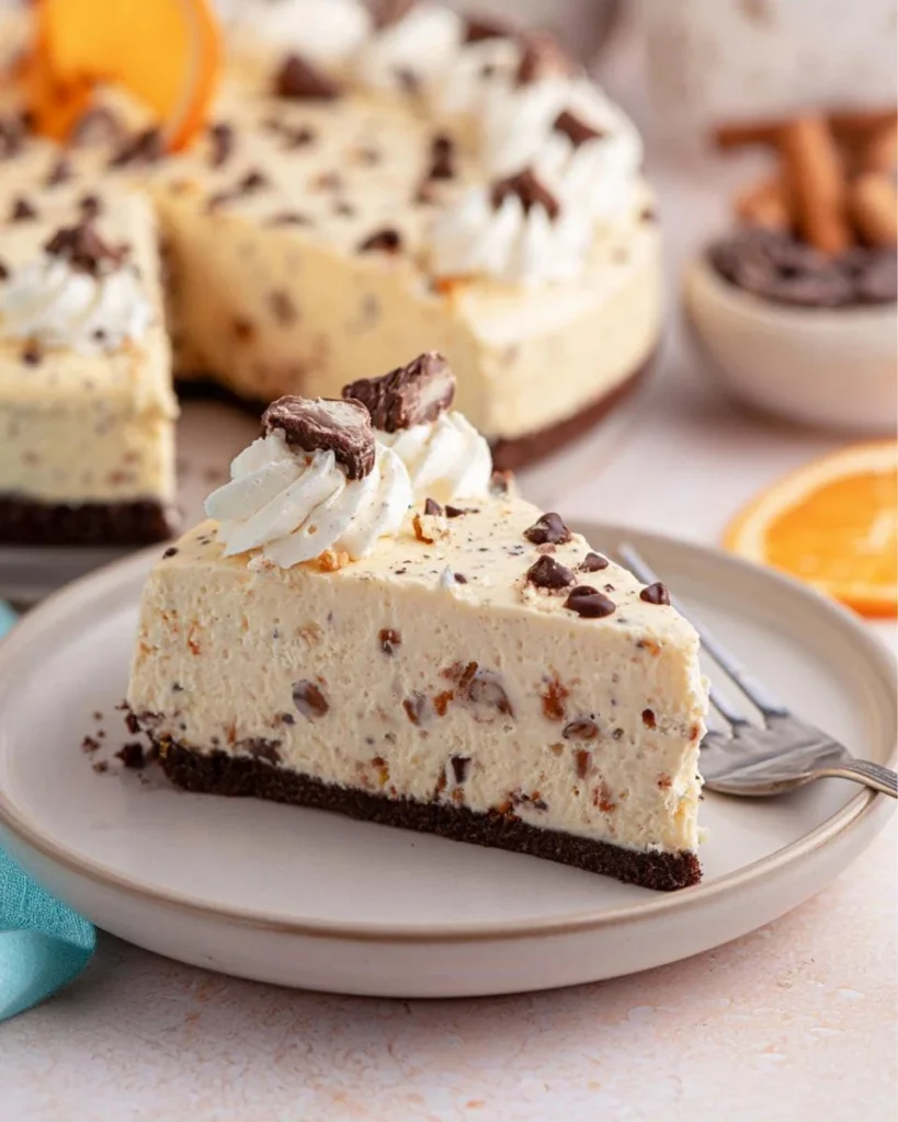 No-bake cannoli cheesecake topped with chocolate chips and whipped cream