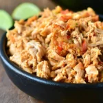 Crock Pot shredded salsa chicken served in a bowl with toppings