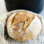 Freshly baked Dutch Oven Bread with a golden crust and soft interior.