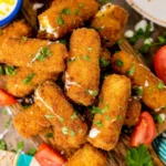 Golden crispy fried mozzarella sticks served with marinara sauce