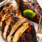 Balsamic marinated grilled chicken sizzling on the barbecue grill