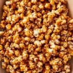 Bowl of homemade caramel popcorn drizzled with rich caramel sauce