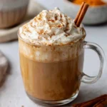 Homemade pumpkin spice latte topped with whipped cream and spices