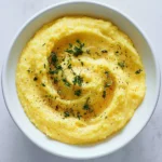 Creamy Instant Pot polenta served with vegetables and herbs