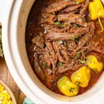 Delicious Mississippi Roast served in a Crock Pot with flavorful seasonings.