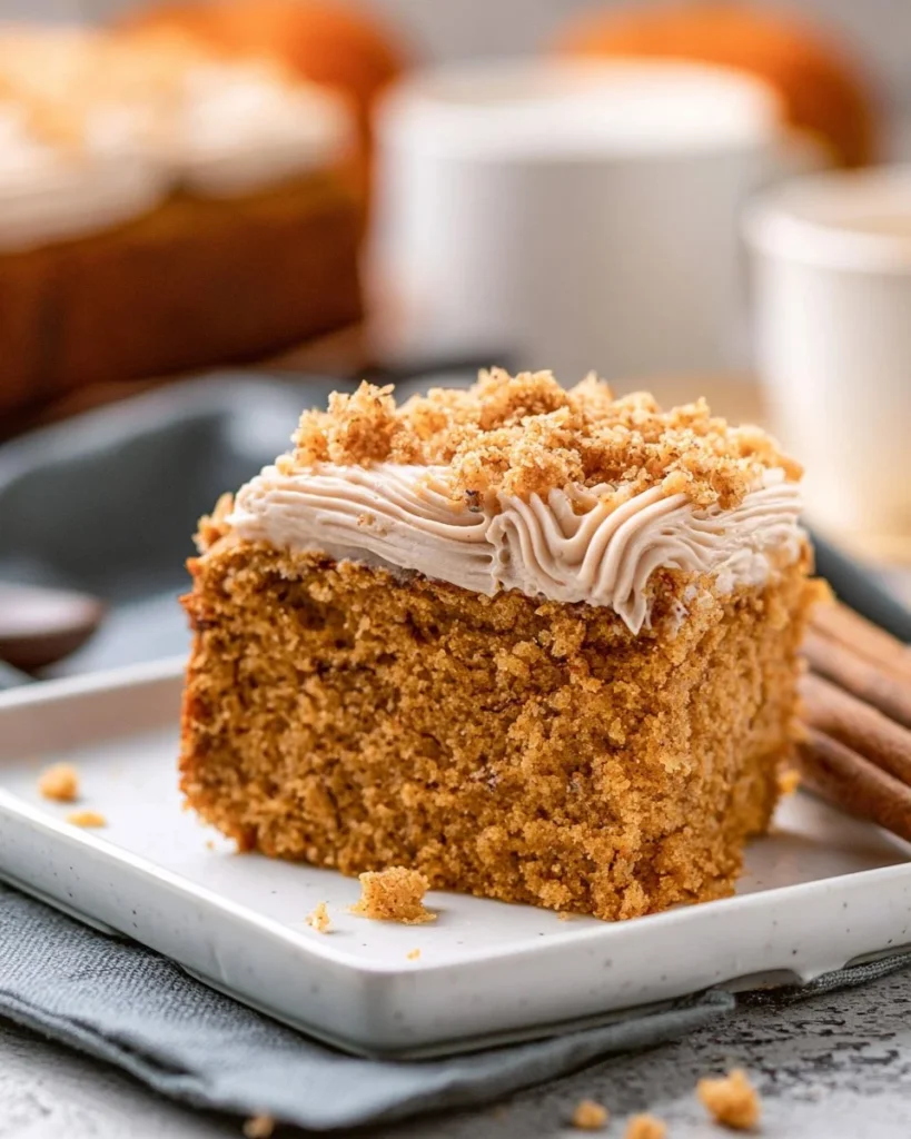 Slice of moist Pumpkin Coffee Cake topped with cinnamon and nuts