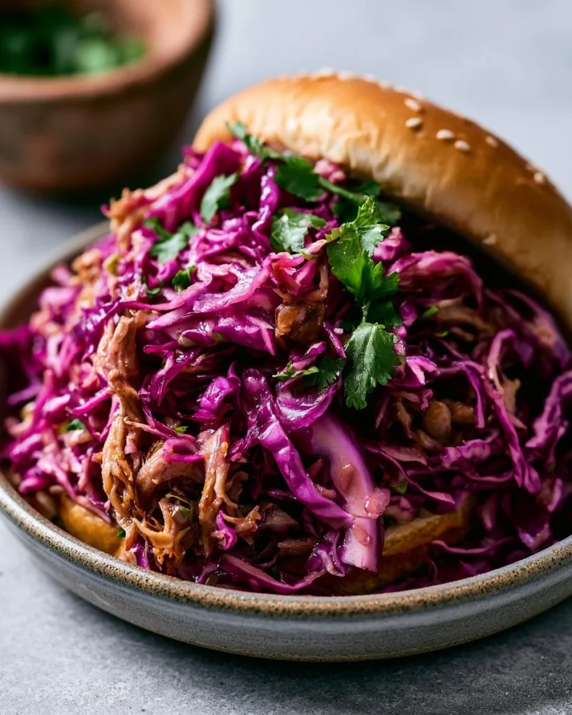 Colorful red cabbage slaw with fresh vegetables and dressing served in a bowl