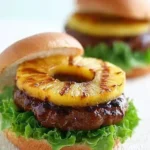 Juicy teriyaki burgers with grilled pineapple, showcasing a delicious fusion of flavors.