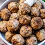 Crispy air fryer meatballs served on a plate with dipping sauce